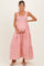 woman wearing a pink striped maternity maxi dress and holding her baby bump