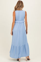 woman wearing a light blue maternity maxi dress with a ruffled waist and tiered hem view from the back