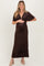 woman wearing a dark brown floral print maternity maxi dress and holding her baby bump