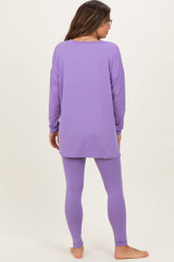 woman wearing a long sleeve lavender maternity top and matching leggings, showing a relaxed fit from the back