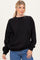 woman wearing a black oversized sweatshirt and blue jeans with a relaxed fit
