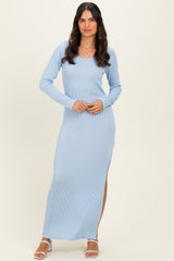 woman wearing a light blue ribbed long sleeve maxi dress with a side split and a scoop neckline