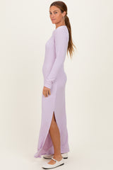 woman wearing a lavender long sleeve ribbed maxi dress with side slits and white flats
