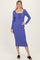 woman wearing a purple ribbed midi dress with a square neckline and drawstring detail, standing and smiling