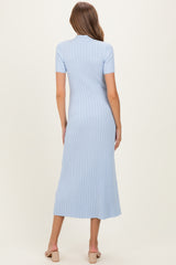 woman wearing a light blue short sleeve ribbed maternity dress with a fitted silhouette and midi length