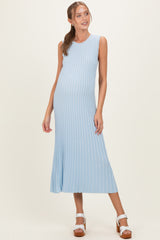 woman wearing a light blue ribbed maternity dress with a flared hem and a visible baby bump