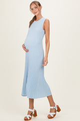 woman wearing a light blue ribbed maternity dress and showing her baby bump