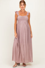 woman wearing a mauve maternity maxi dress with ruffle details and a smocked bodice, showcasing her baby bump