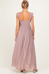 woman wearing a mauve maternity maxi dress with ruffle straps and a smocked back detailing