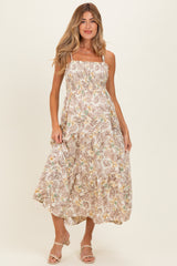 woman wearing a floral print maternity maxi dress with smocked bodice and spaghetti straps, model standing and smiling