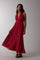 woman wearing a red halter neck maxi dress with white polka dots and a flowing skirt