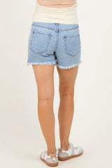 woman wearing light blue maternity denim shorts with frayed hems, seen from the back