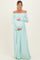 woman wearing a light mint off-shoulder maternity gown and holding her baby bump