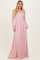 woman wearing a long pink lace off-shoulder maxi dress with long sleeves and a flowing silhouette