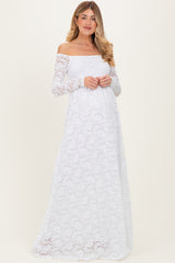 woman wearing a white off-the-shoulder long sleeve lace maternity dress with a flowing skirt and a relaxed fit