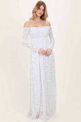woman wearing a white off-the-shoulder long sleeve lace maxi dress