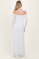 woman wearing a white off-shoulder lace maxi dress with long sleeves, seen from the back