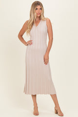 woman wearing a light beige ribbed sleeveless midi dress with a v-neck and relaxed fit