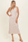 woman wearing a light beige ribbed sleeveless midi dress with a v-neck and relaxed fit