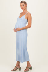 woman wearing a light blue ribbed maternity dress with a v-neck and a visible baby bump