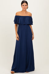 woman wearing a navy blue off-the-shoulder maxi dress with ruffled sleeves and an elastic waistband