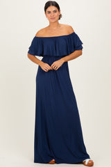 woman wearing a navy blue off-the-shoulder maxi dress with ruffled sleeves and a cinched waist