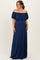 woman wearing a navy blue off-shoulder maternity maxi dress with ruffled sleeves and a relaxed fit, showing her baby bump