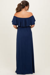 woman wearing a navy blue off-the-shoulder maternity dress with ruffle details, showing her back