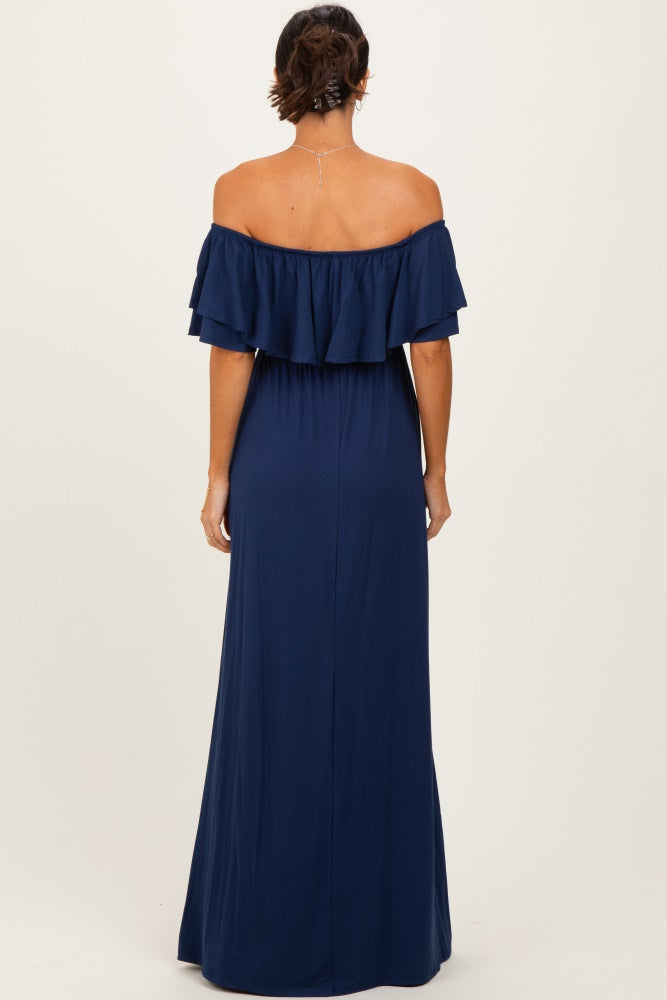 woman wearing a navy off-the-shoulder maxi dress with ruffled sleeves, seen from the back