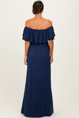 woman wearing a navy off-the-shoulder maxi dress with ruffled sleeves, seen from the back