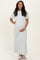 woman wearing a white and gray striped maternity maxi dress and holding her baby bump
