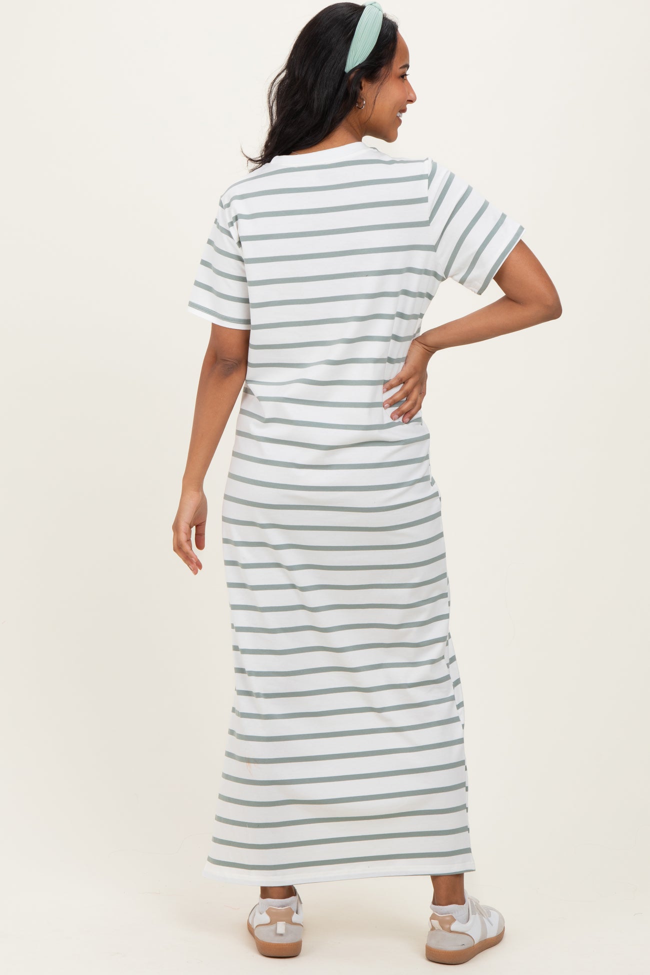 woman wearing a striped maternity maxi dress with short sleeves and a relaxed fit