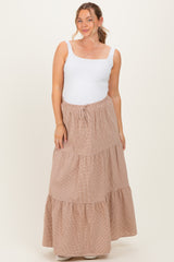woman wearing a white tank top and a beige striped maternity maxi skirt with a tiered design and drawstring waist