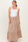 woman wearing a white tank top and a beige striped maternity maxi skirt with a tiered design and drawstring waist