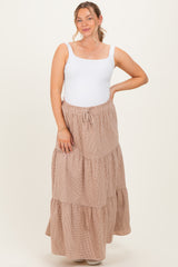 woman wearing a white tank top and a long tiered maternity skirt in light beige with an elastic waistband and drawstring