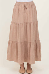 woman wearing a brown and white checked tiered maxi skirt with an elastic waistband and drawstring detail