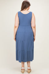woman wearing a blue maternity plus tiered maxi dress, shown from the back with no visible baby bump