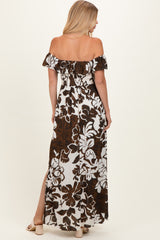 woman wearing a brown and white floral off-the-shoulder maxi dress with a side slit