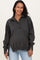 woman wearing a dark grey maternity sweatshirt with a collared neckline and button details, smiling at the camera