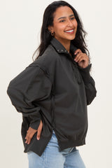 woman wearing a dark gray maternity pullover sweatshirt with a half zipper and relaxed fit, showing baby bump