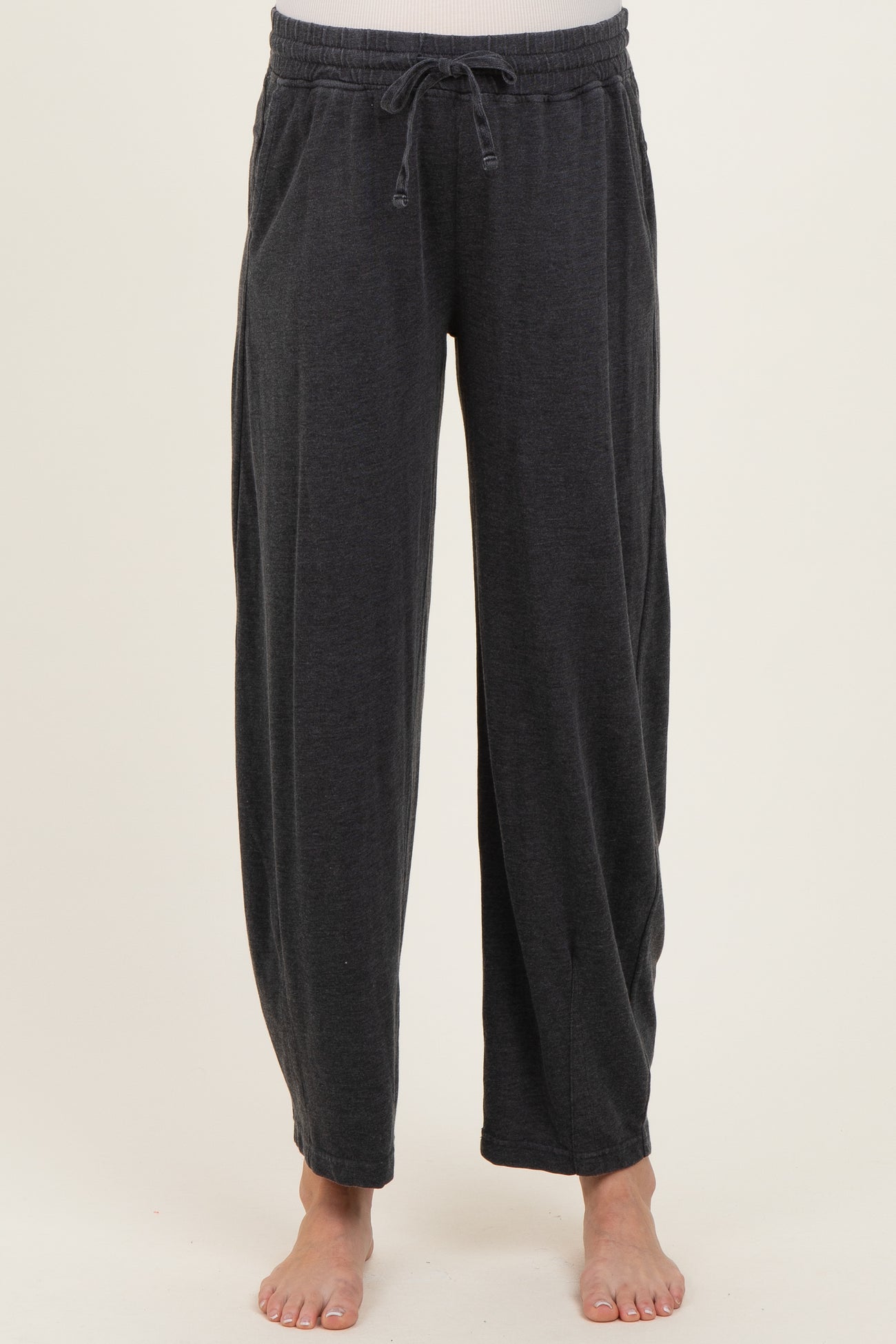 woman wearing dark gray maternity lounge pants with an elastic waistband and side pockets