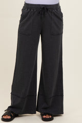 woman wearing dark gray maternity wide-leg pants with pockets and an elastic waistband