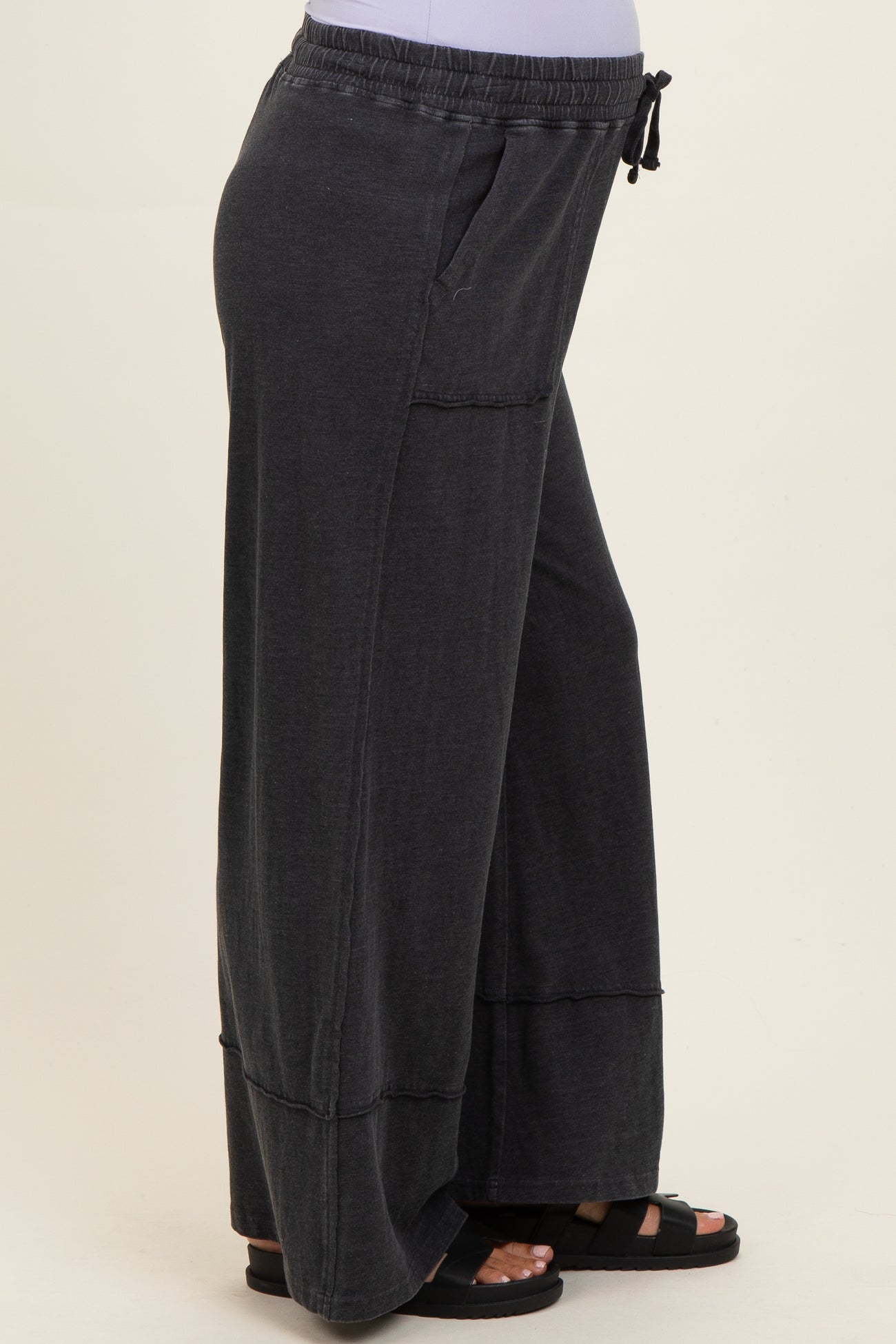 woman wearing dark gray comfy maternity wide-leg pants with elastic waistband and side pockets