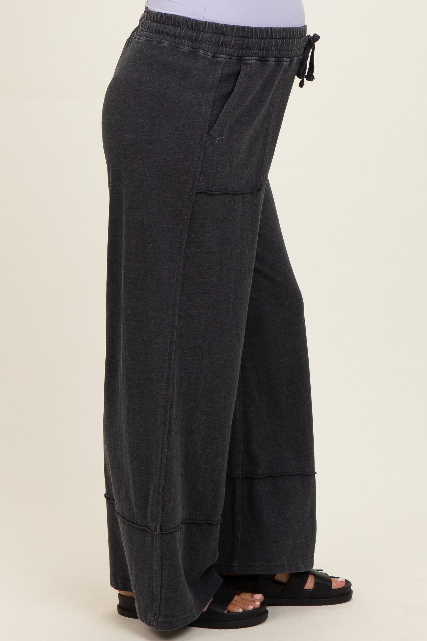 woman wearing dark gray comfy maternity wide-leg pants with elastic waistband and side pockets