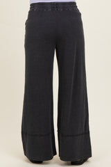 black wide-leg maternity pants with an elastic waistband and a relaxed fit, shown from the back