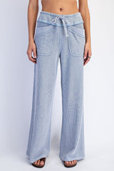 woman wearing light blue wide-leg corduroy pants with side pockets and drawstring waist