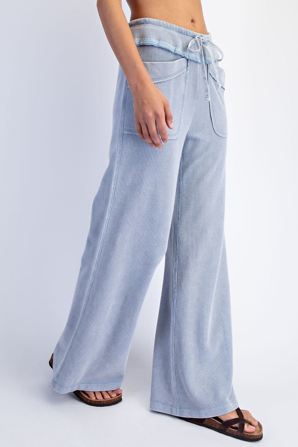 woman wearing light blue wide-leg corduroy pants with drawstring waist and side pockets