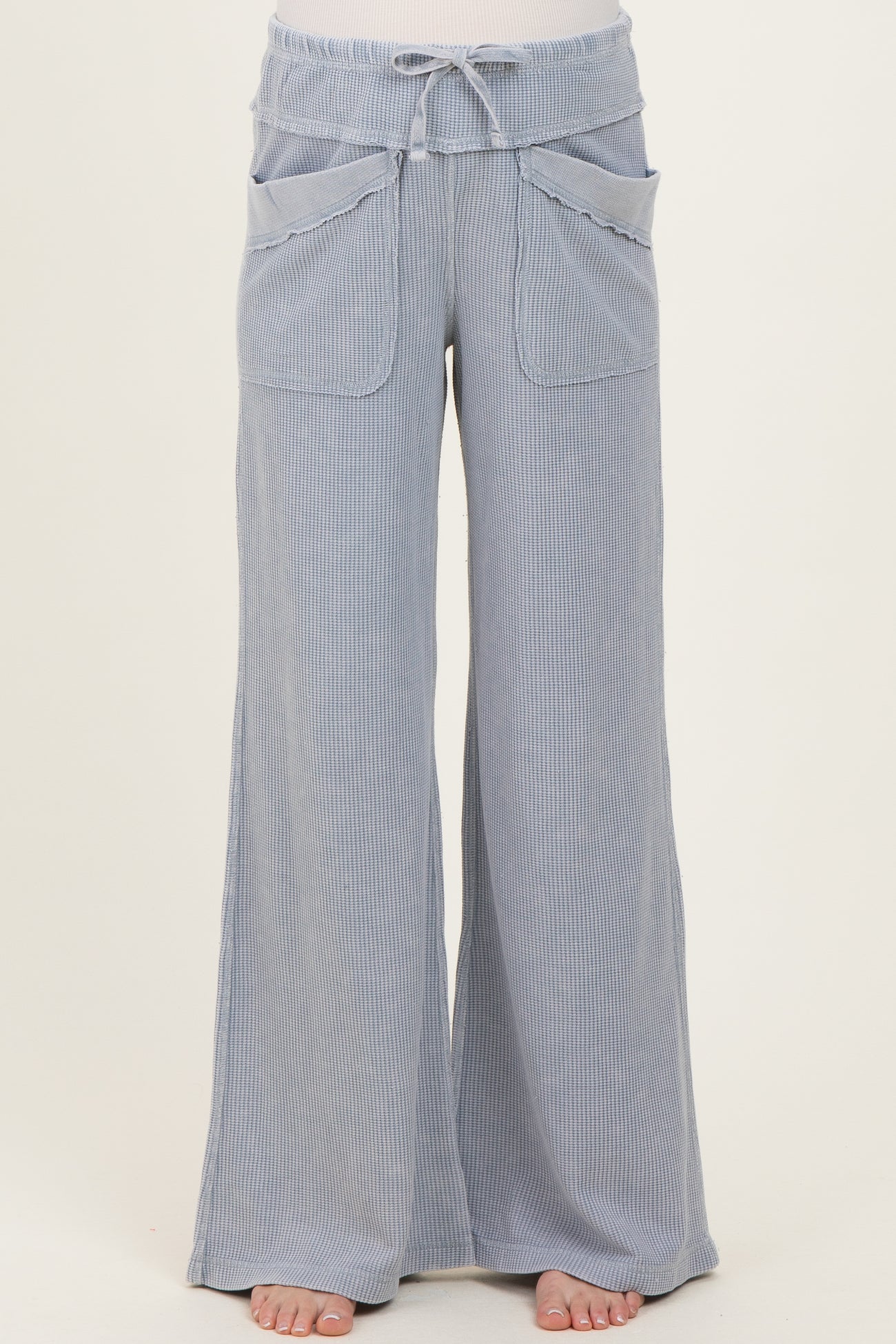 maternity wear light blue wide-leg pants with a drawstring waist and front pockets