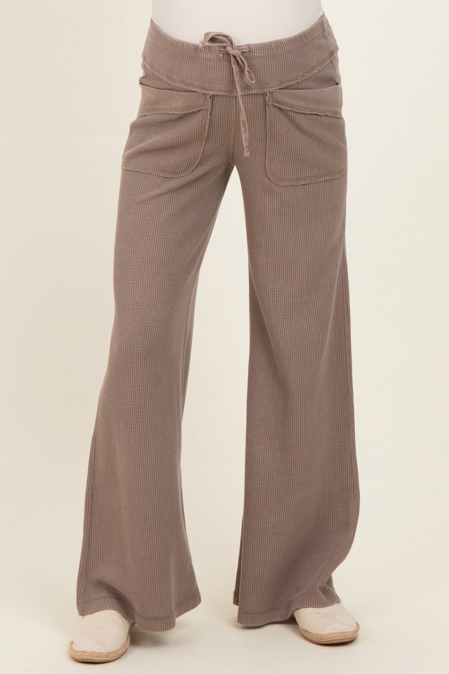 woman wearing light brown wide leg maternity pants with drawstring and front pockets