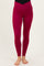woman wearing high-waisted burgundy maternity leggings with a crossover waistband